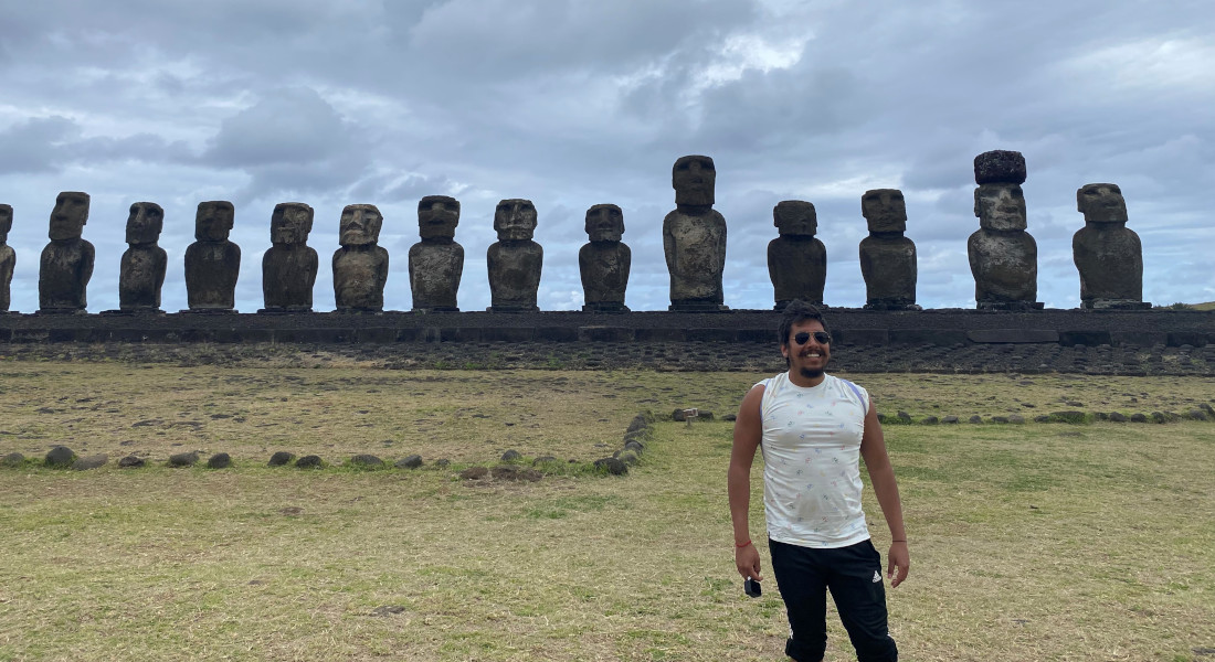 Víctor Moreno-Mayar standing in front of Moai on Rapa Nui.