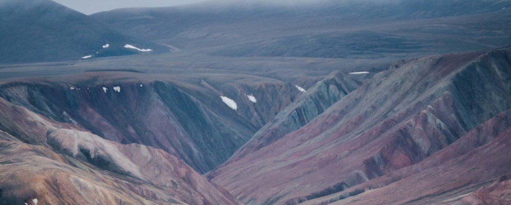 Picturesque mountain landscape in red and yellow colors, located at Ellesmere Island.